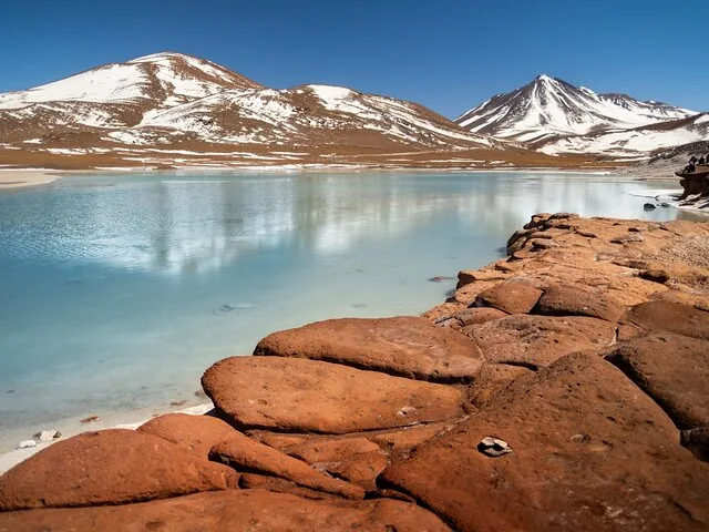 Woman floating on her back in a bright blue salt lake.