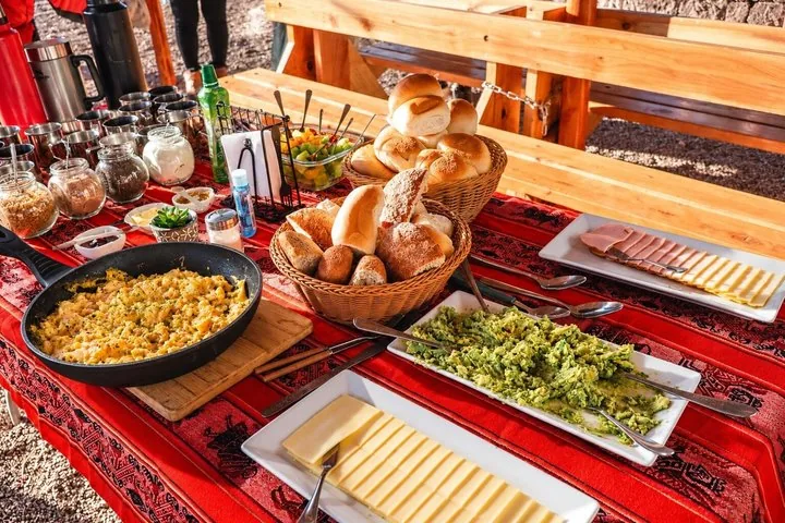 Breakfast buffet spread with scrambled eggs, bread, cheese, and avocado.